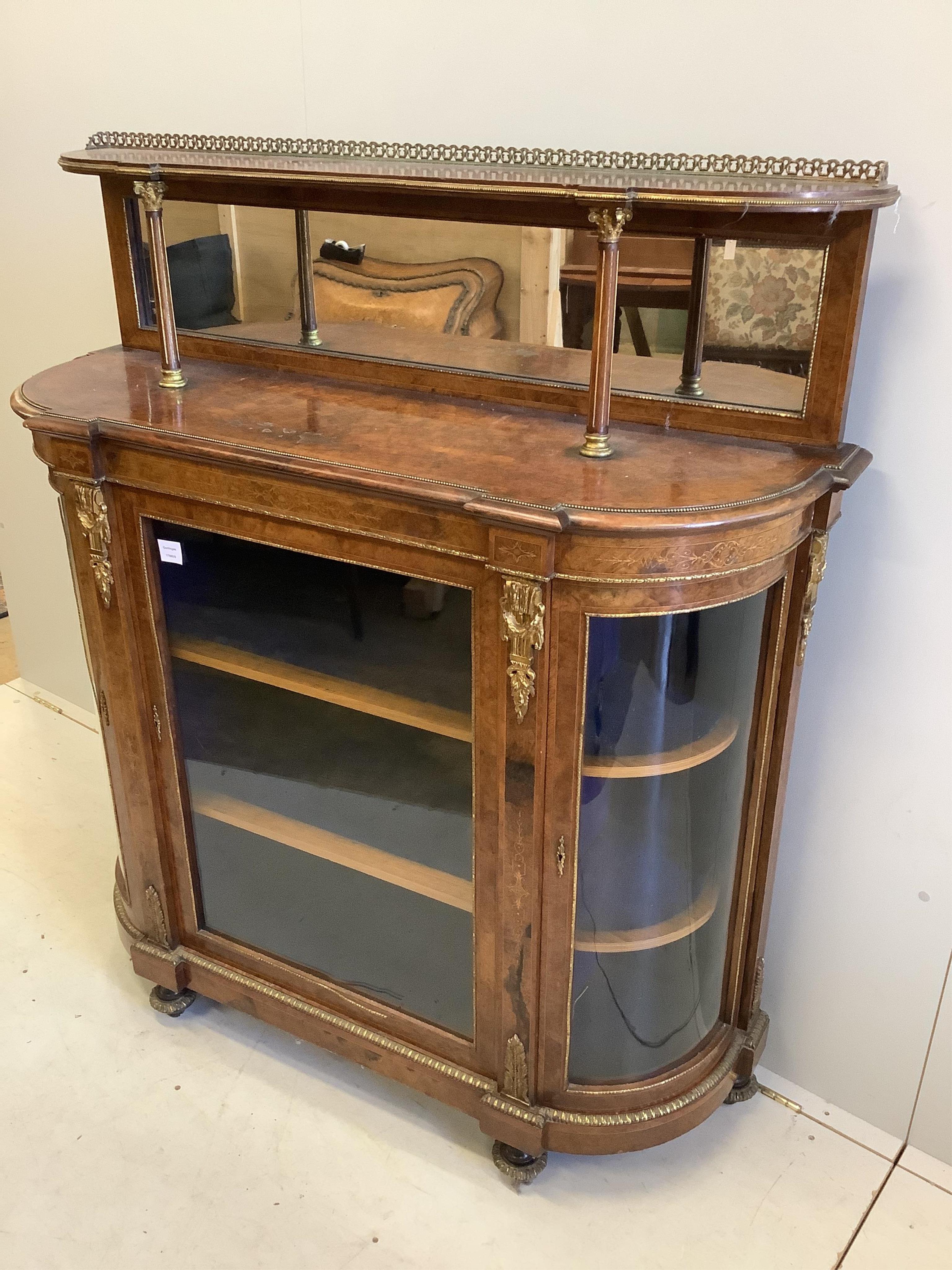 A Victorian gilt metal mounted burr walnut bowfront side cabinet, with mirrored tier back, width 125cm, depth 42cm, height 140cm